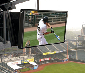 An outdoor screen within the Daedalus-designed enclosure is shown. The screen is displaying a baseball game, and the screen is within a baseball stadium.