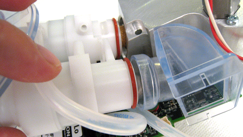 A detail view of the assembly of the blender is shown. Gaskets, circuits, and molded plastic manifolds are visible.