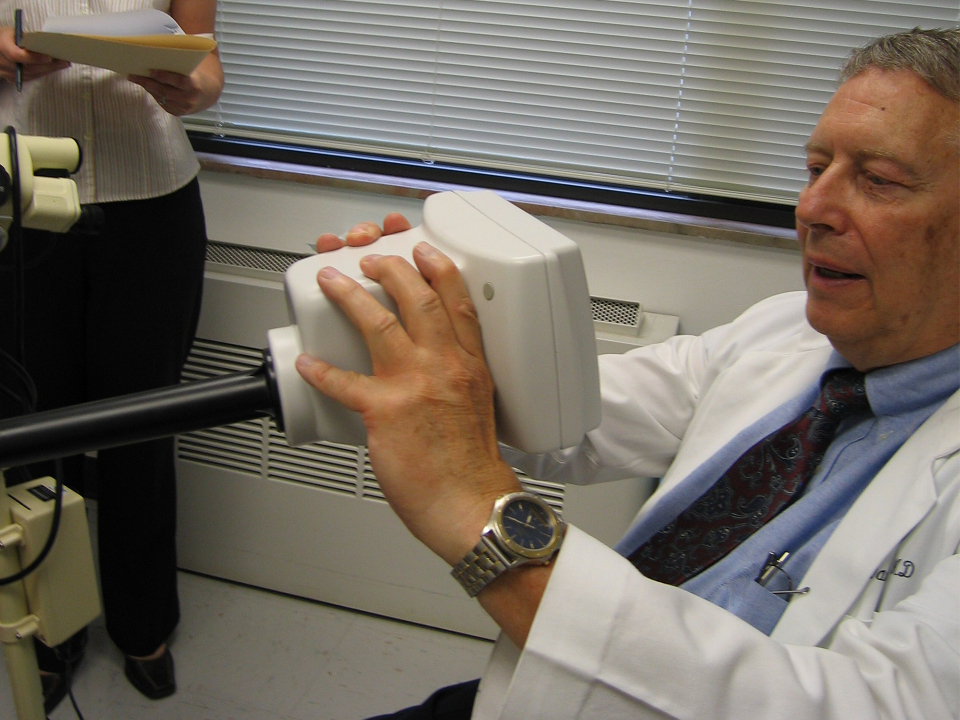 A doctor is interacting with the device in a clinical setting during an interview and demonstration session.